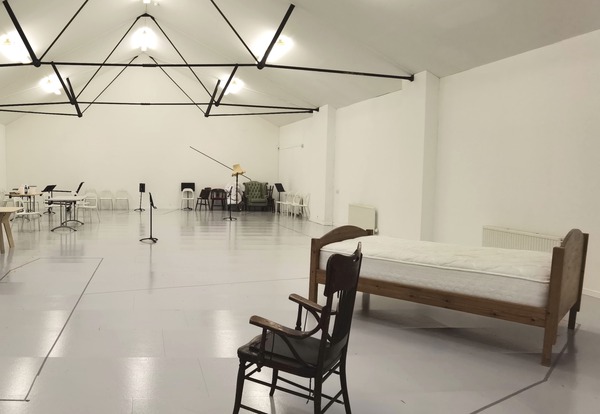 Large Space with White Walls and Grey Floor with Furniture