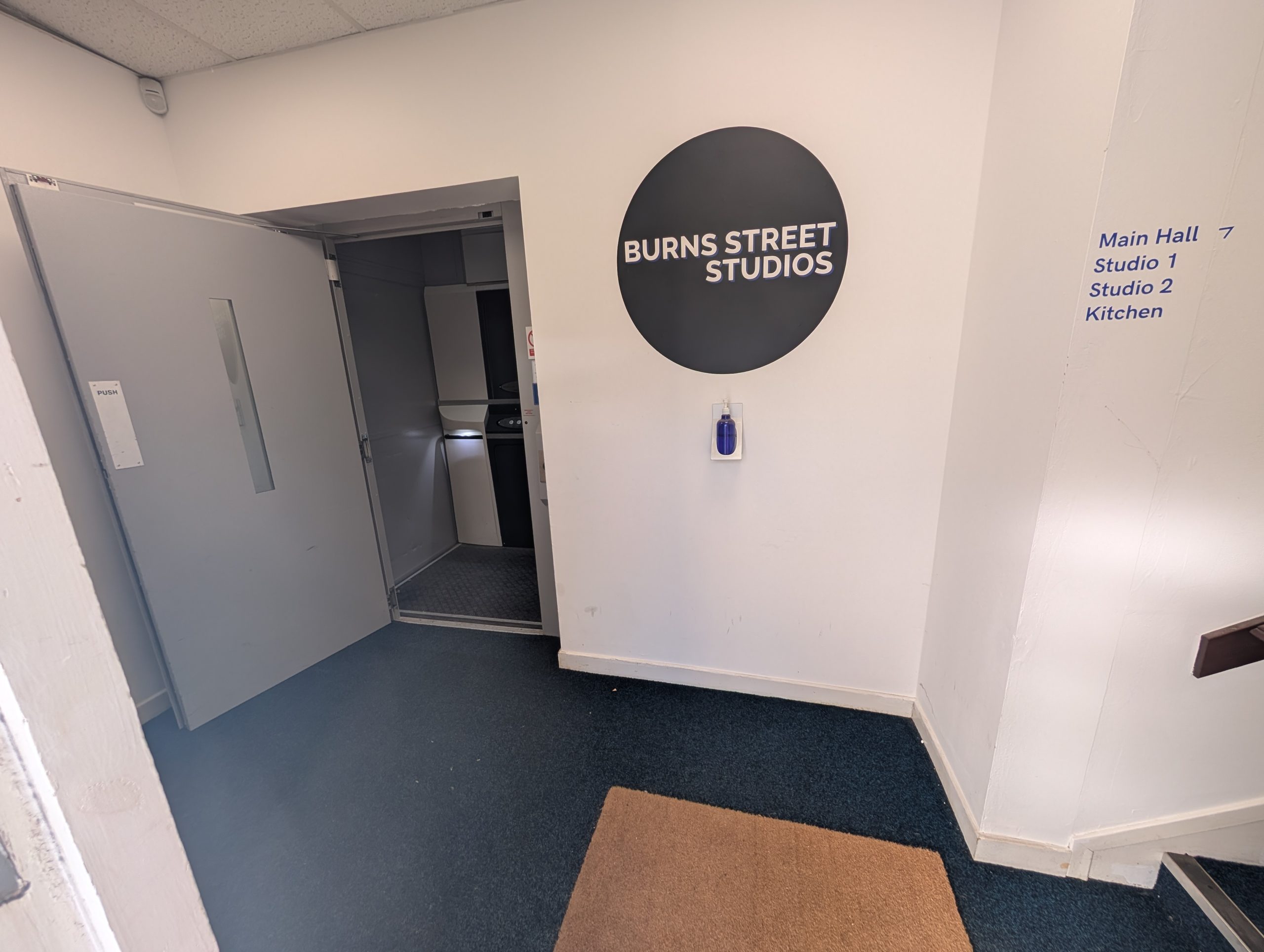 Accessible entrance to Burns Street Studios with wheelchair lift and step-free access in Glasgow